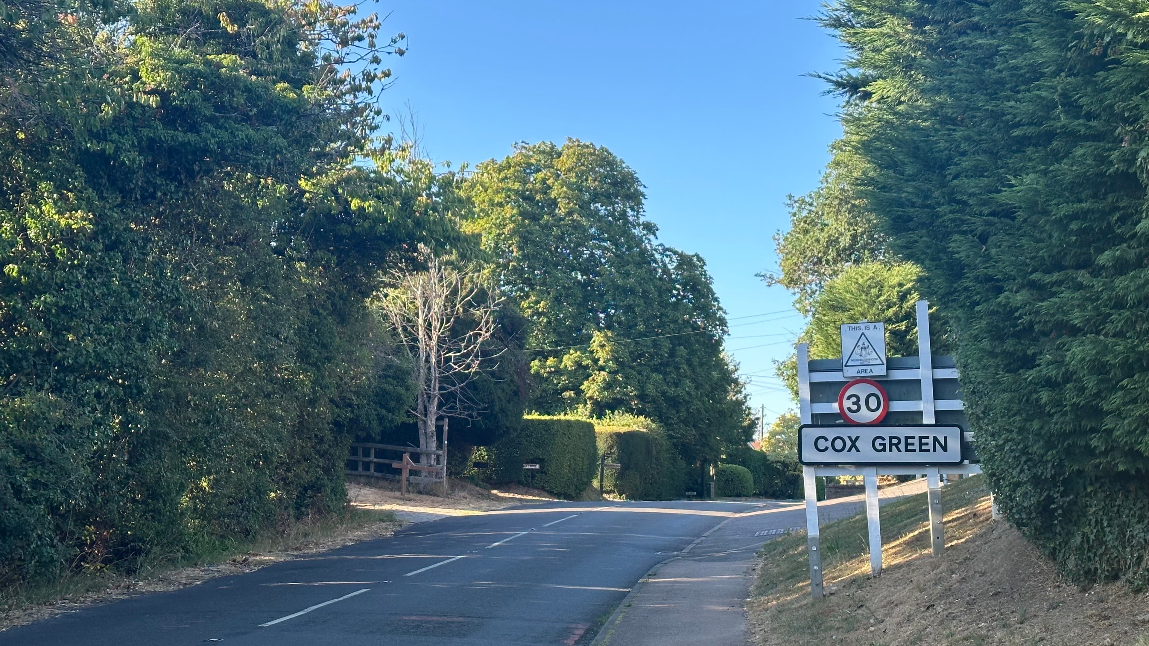The road into Cox Green, with the Cox Green nameplate sign